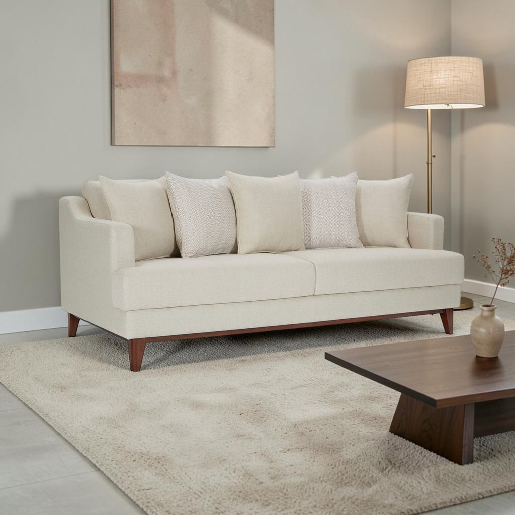 Homecrest Halden mid-century modern sofa in cream fabric with tapered teak wood legs in a minimalist living room.