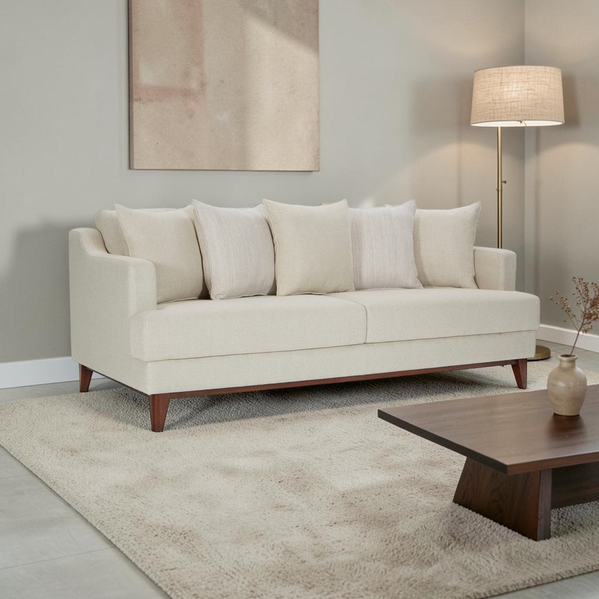 Homecrest Halden mid-century modern sofa in cream fabric with tapered teak wood legs in a minimalist living room.