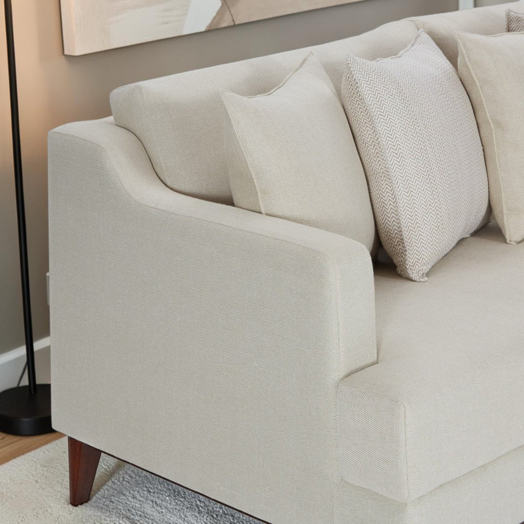 Homecrest Halden mid-century lounge sofa in beige fabric with tapered wood legs and decorative throw pillows