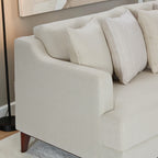 Homecrest Halden mid-century lounge sofa in beige fabric with tapered wood legs and decorative throw pillows