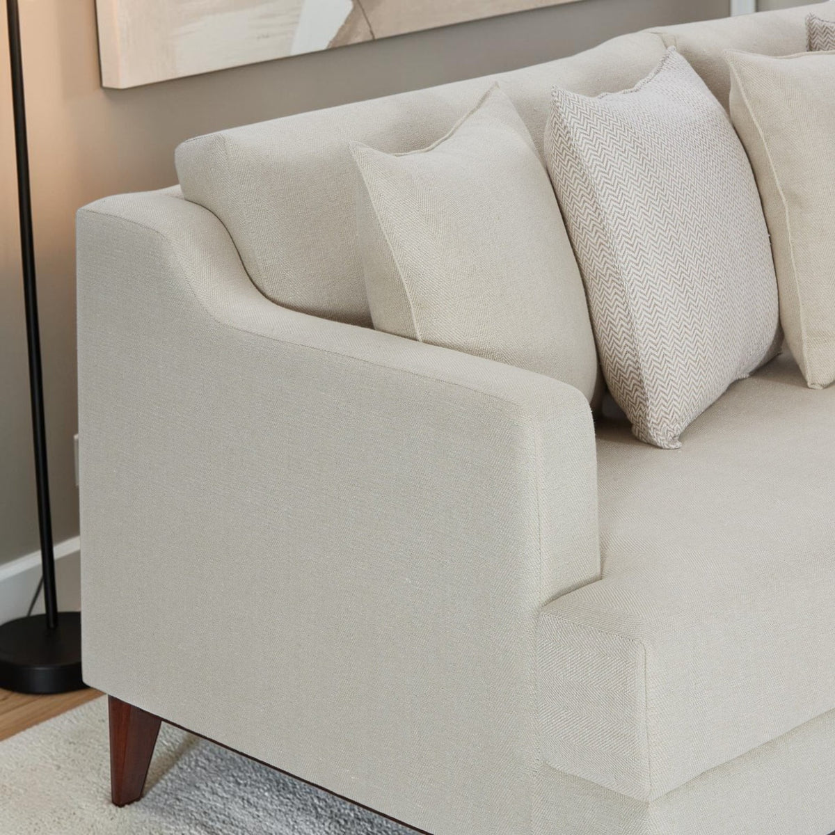 Homecrest Halden mid-century lounge sofa in beige fabric with tapered wood legs and decorative throw pillows