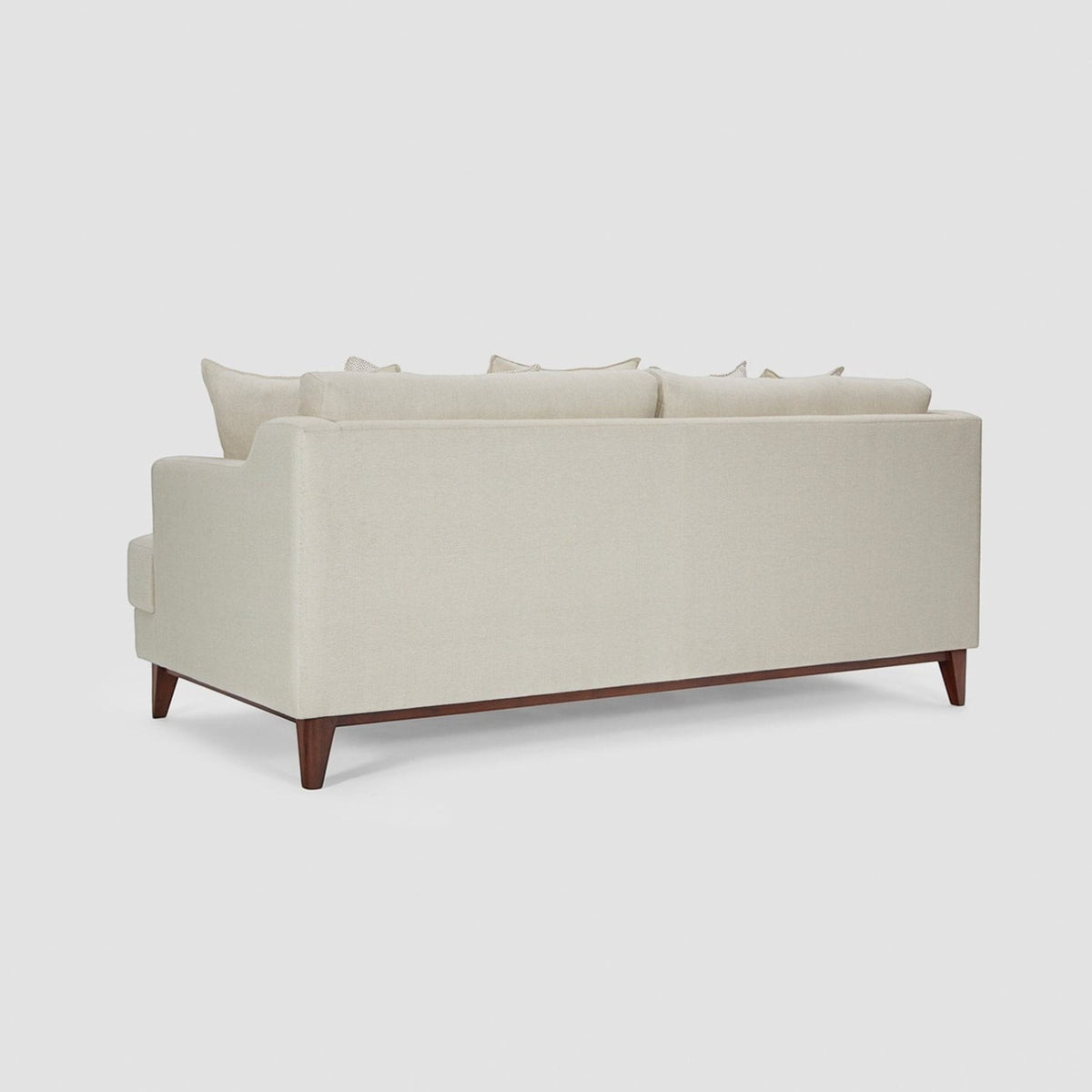 Homecrest Halden mid-century lounge sofa in beige fabric with a dark teak wood base and tapered legs, rear view.