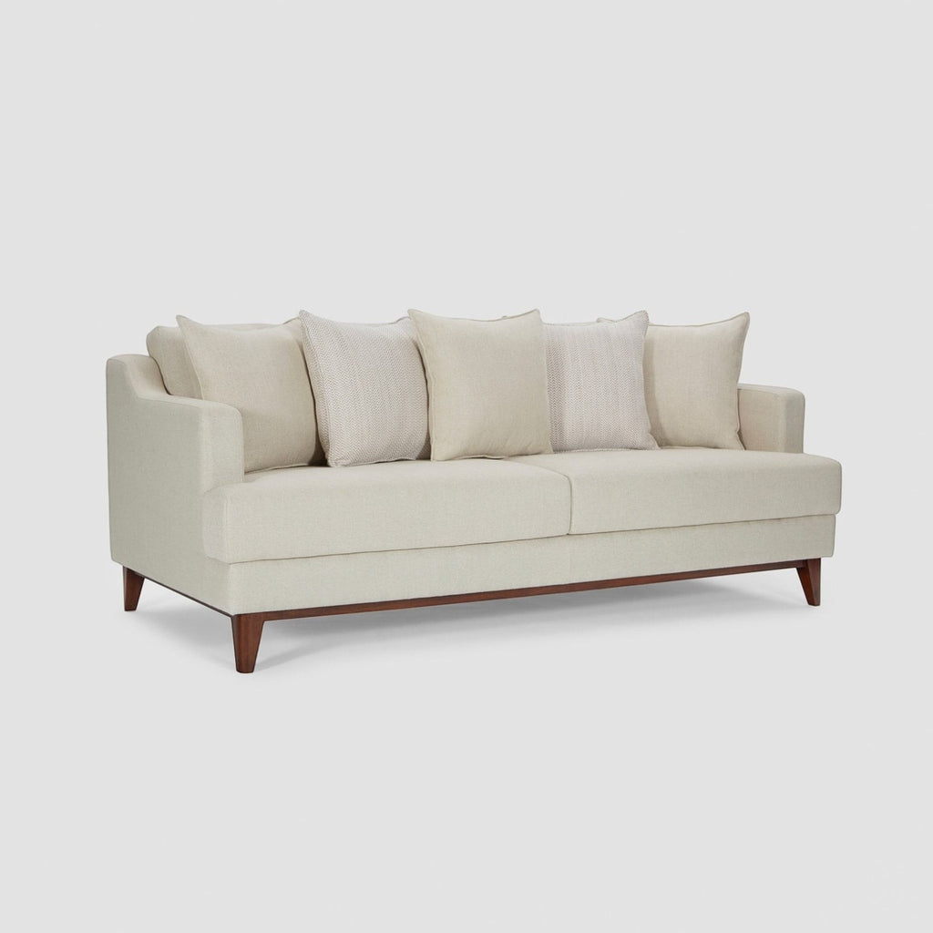 Homecrest Halden mid-century modern sofa in cream fabric with tapered teak wood legs in a minimalist living room.