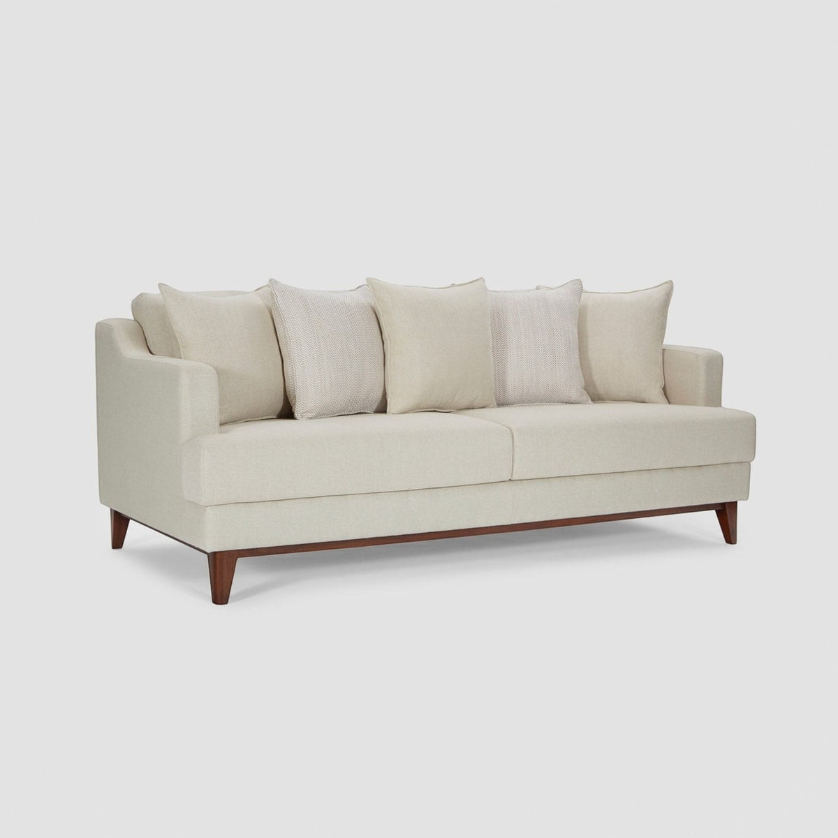 Homecrest Halden mid-century modern sofa in cream fabric with tapered teak wood legs in a minimalist living room.