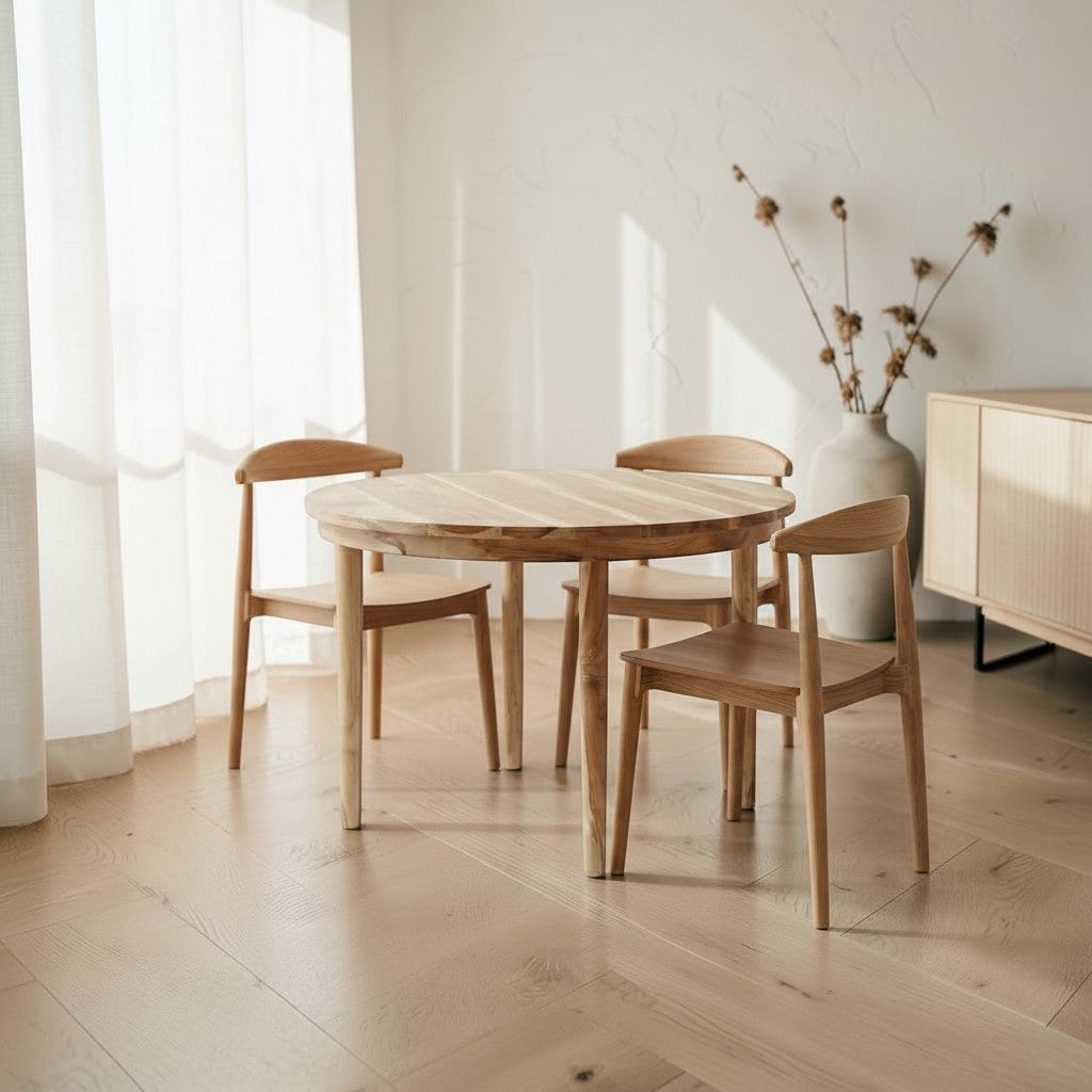 Homecrest Halland round sheesham wood dining table with minimalist Scandinavian design in a bright, airy room.