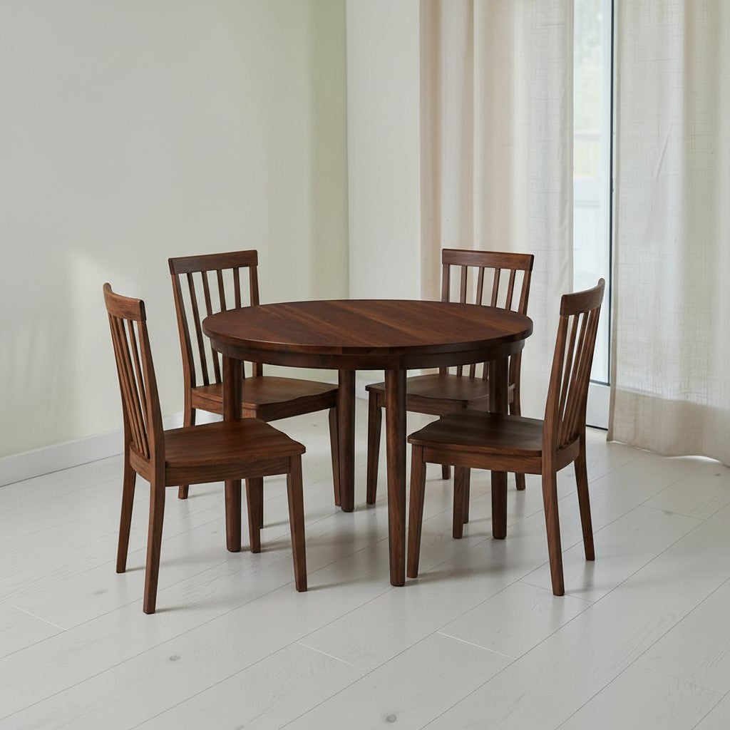 Homecrest Halland round dining table in dark wood with four matching spindle-back chairs in a bright dining room.