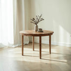Homecrest Halland round dining table in sheesham wood with a minimal Scandinavian design in a bright living space