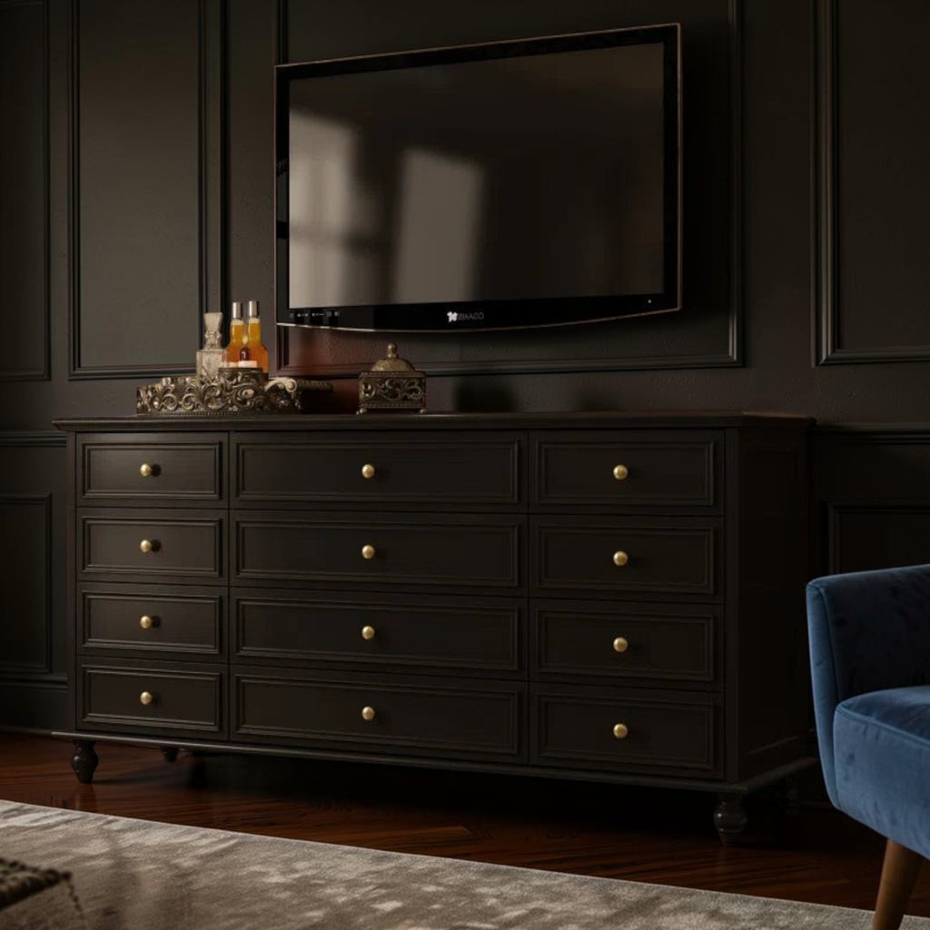 Homecrest Halstead twelve-drawer chest in black wood with gold knobs, positioned as a console under a wall-mounted TV.