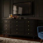 Homecrest Halstead twelve-drawer chest in black wood with gold knobs, positioned as a console under a wall-mounted TV.