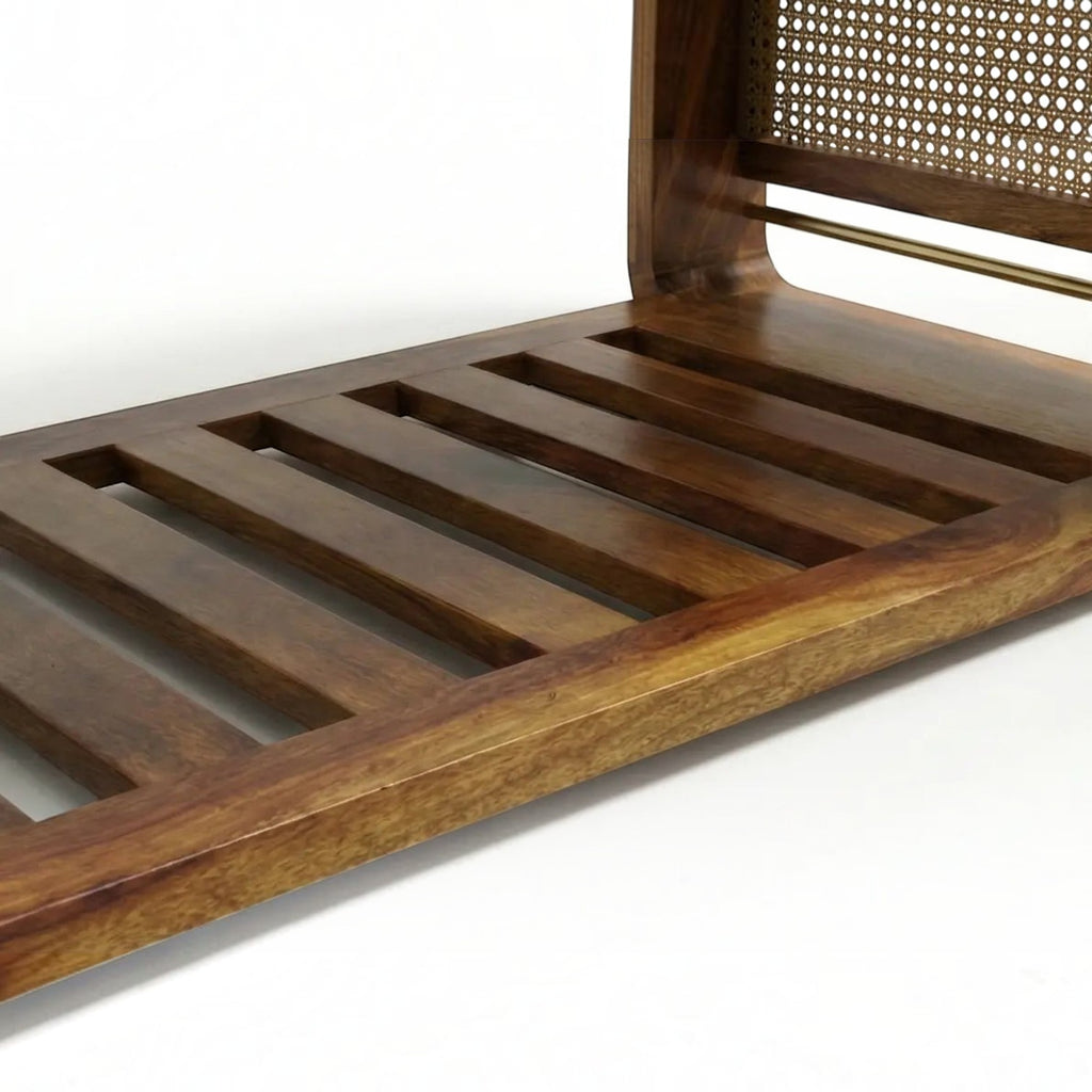 Homecrest Ilva coffee table featuring a slatted Sheesham wood base and a decorative rattan cane panel side detail.