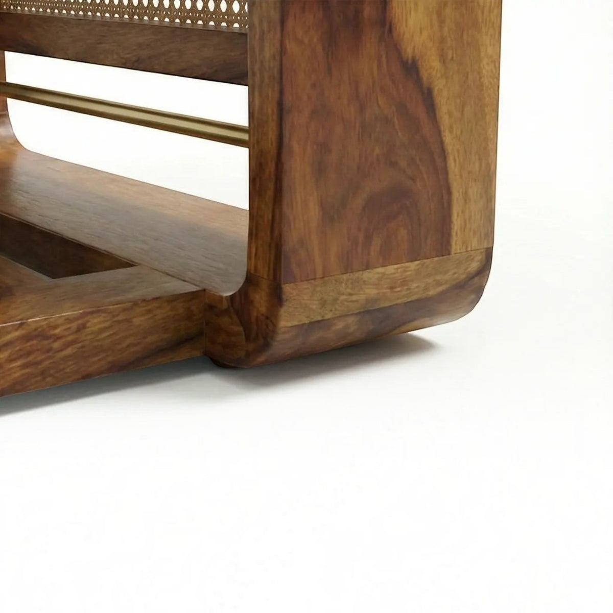 Homecrest Ilva coffee table featuring a curved Sheesham wood frame and intricate rattan cane panel detailing.