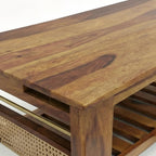 Homecrest Ilva rectangular coffee table made of rich brown Sheesham wood with natural rattan cane panel detailing.