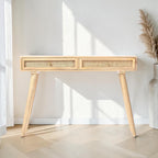 Homecrest Isla natural wood console table with two woven rattan cane drawers and gold handles in a bright hallway.