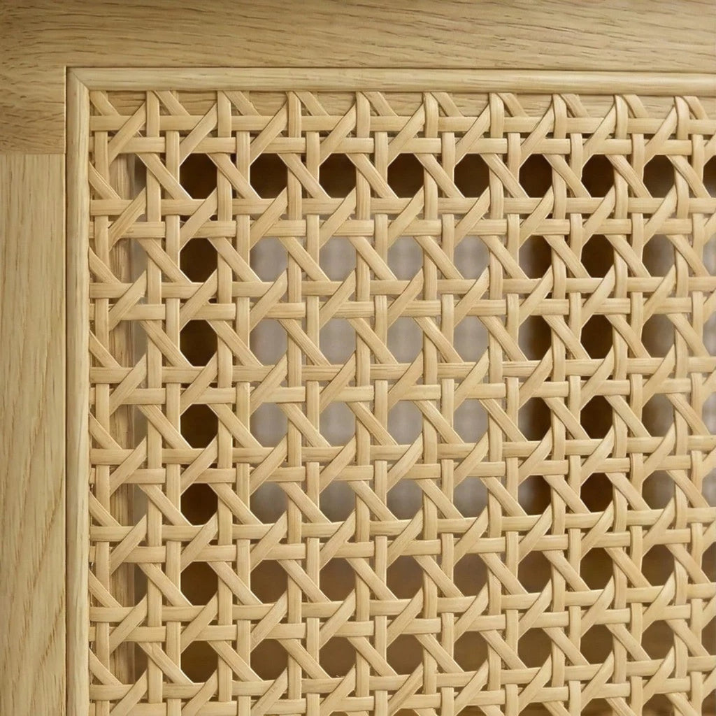 Close-up of the Homecrest Juno coffee table featuring intricate natural woven cane paneling framed in light solid wood.