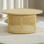 Homecrest Juno round coffee table in light natural wood with woven cane side panels and a lower circular shelf.