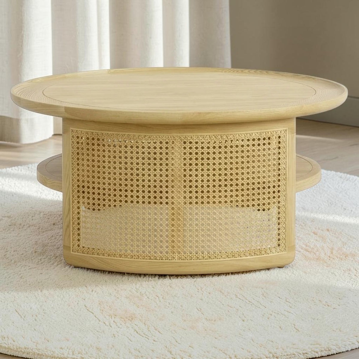 Homecrest Juno round coffee table in light natural wood with woven cane side panels and a lower circular shelf.