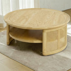Homecrest Juno round coffee table in light natural wood with woven cane side panels and a lower circular shelf.