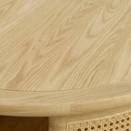 Homecrest Juno round coffee table in light natural wood with woven cane side panels and a smooth circular top