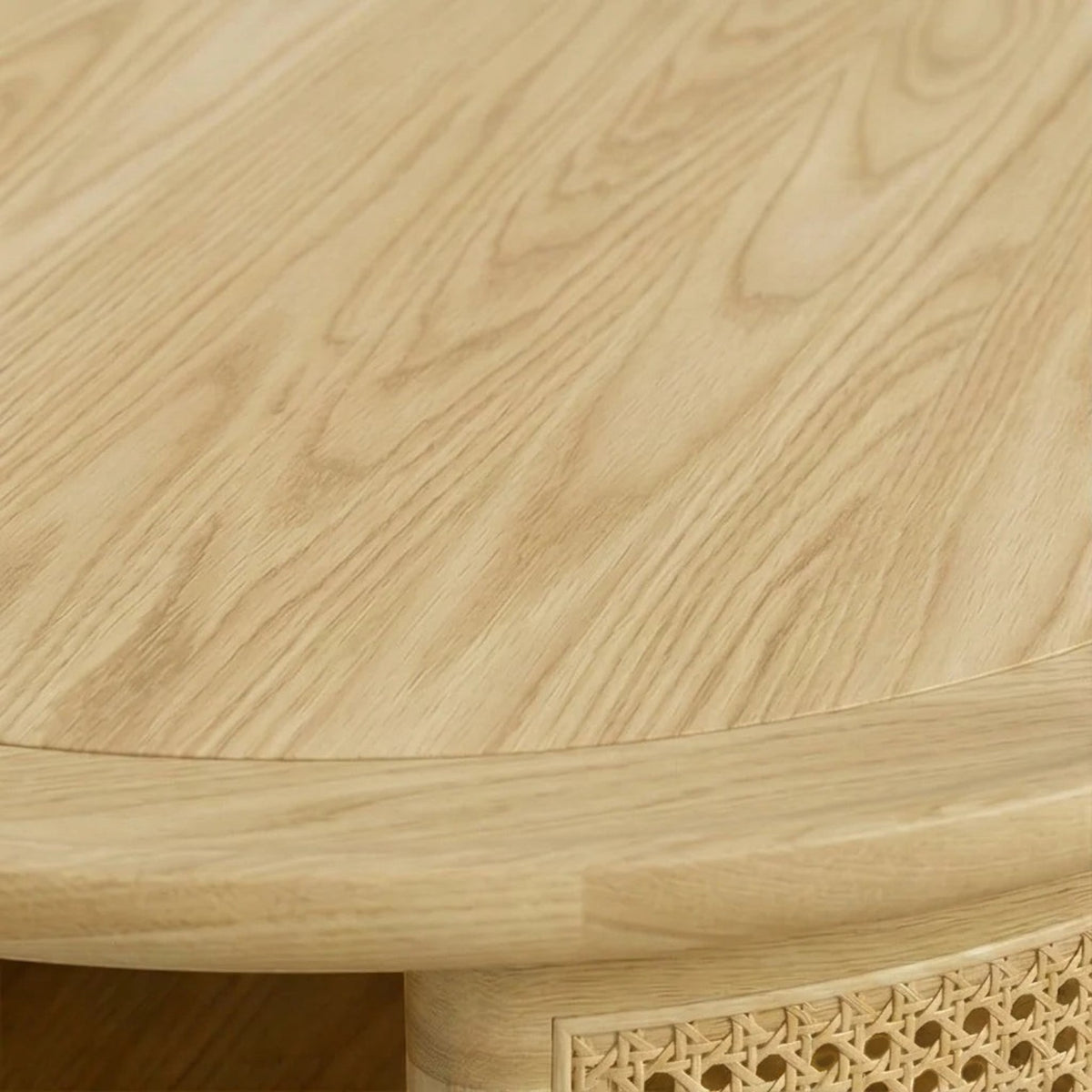 Homecrest Juno round coffee table in light natural wood with woven cane side panels and a smooth circular top
