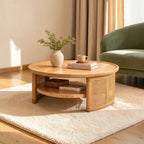 Homecrest Juno round coffee table in light natural wood with woven cane side panels and a lower storage shelf.
