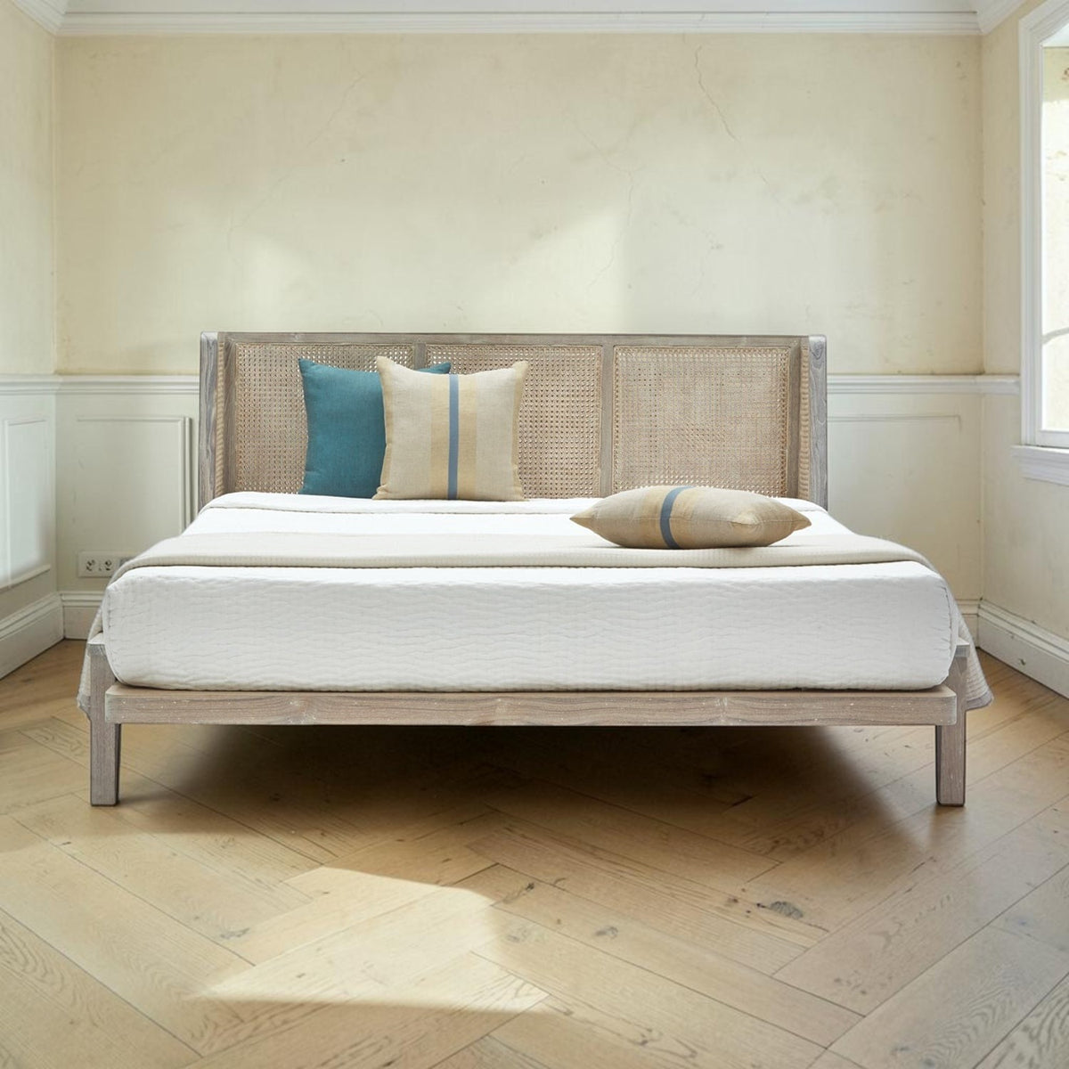 Homecrest Kelsale teakwood platform bed with a natural wicker winged headboard and white Belgian Monocoat finish.