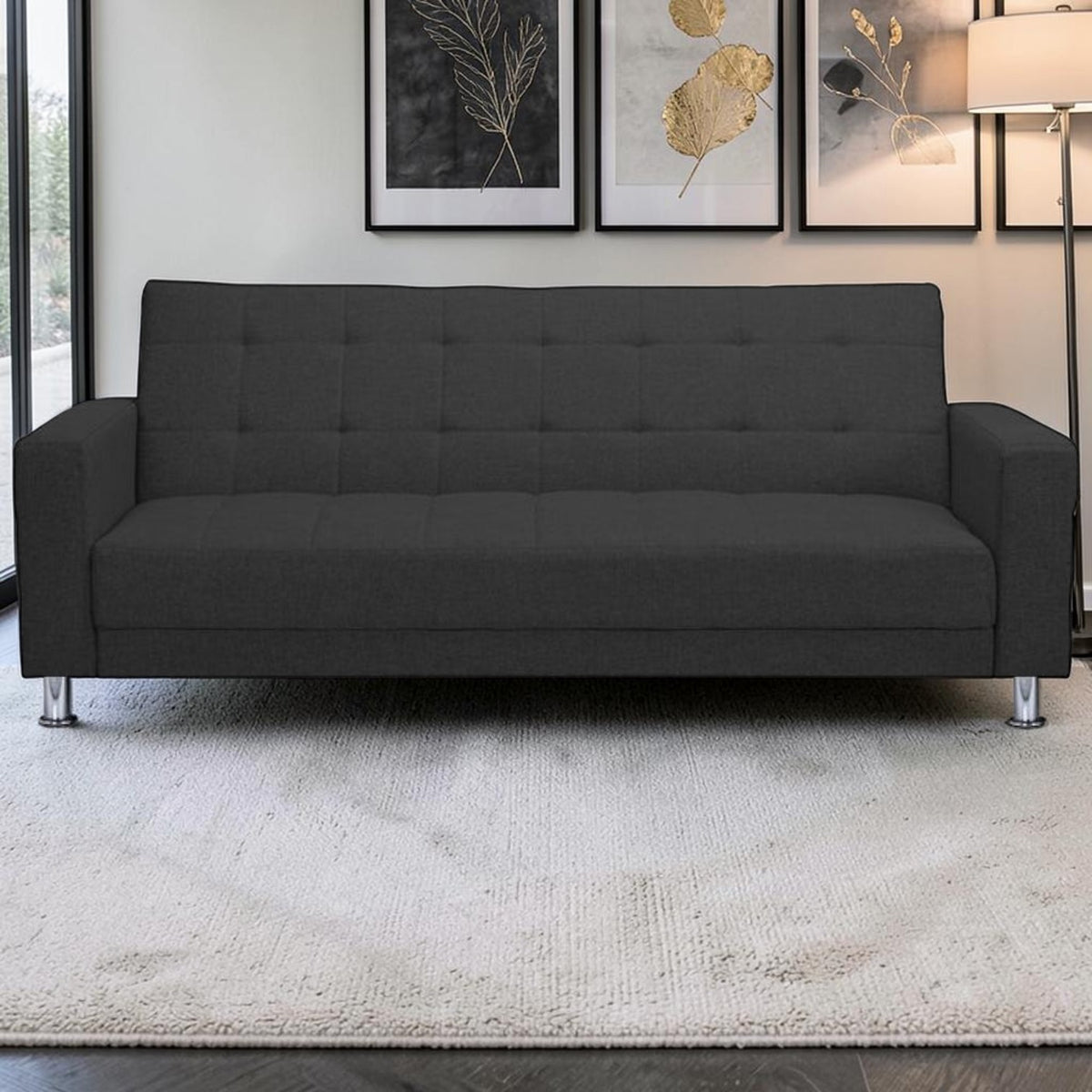 Homecrest Kesler dark grey polyester three-seater sofa cum bed with tufted back and chrome legs in a modern living room
