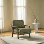 Homecrest Lars Scandi accent chair with olive green bouclé upholstery and a solid wood frame in a bright room.
