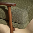 Homecrest Lars Scandi accent chair featuring a dark wood frame and textured olive green bouclé cushioned seat