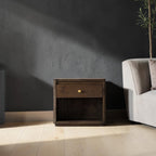 Homecrest Latimer bedside table in dark stained solid wood with a single drawer and brass knob in a modern bedroom.