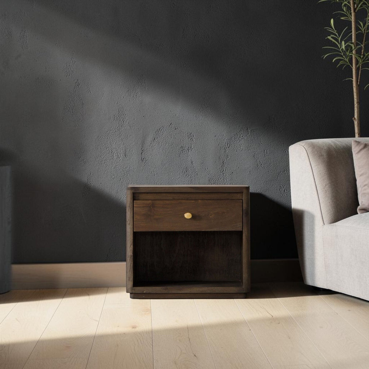 Homecrest Latimer bedside table in dark stained solid wood with a single drawer and brass knob in a modern bedroom.
