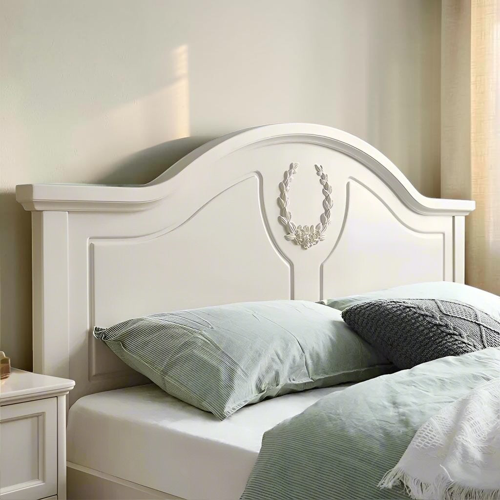 Homecrest luxury standard bed in light beige finish with a curved headboard featuring elegant floral wreath carving.