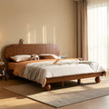 Homecrest light walnut Sheesham wood platform bed with a curved grid headboard and unique spherical legs in a bedroom