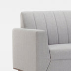 Homecrest Lindholm Scandinavian statement sofa in light grey fabric with a channel-tufted back and teak wood base.