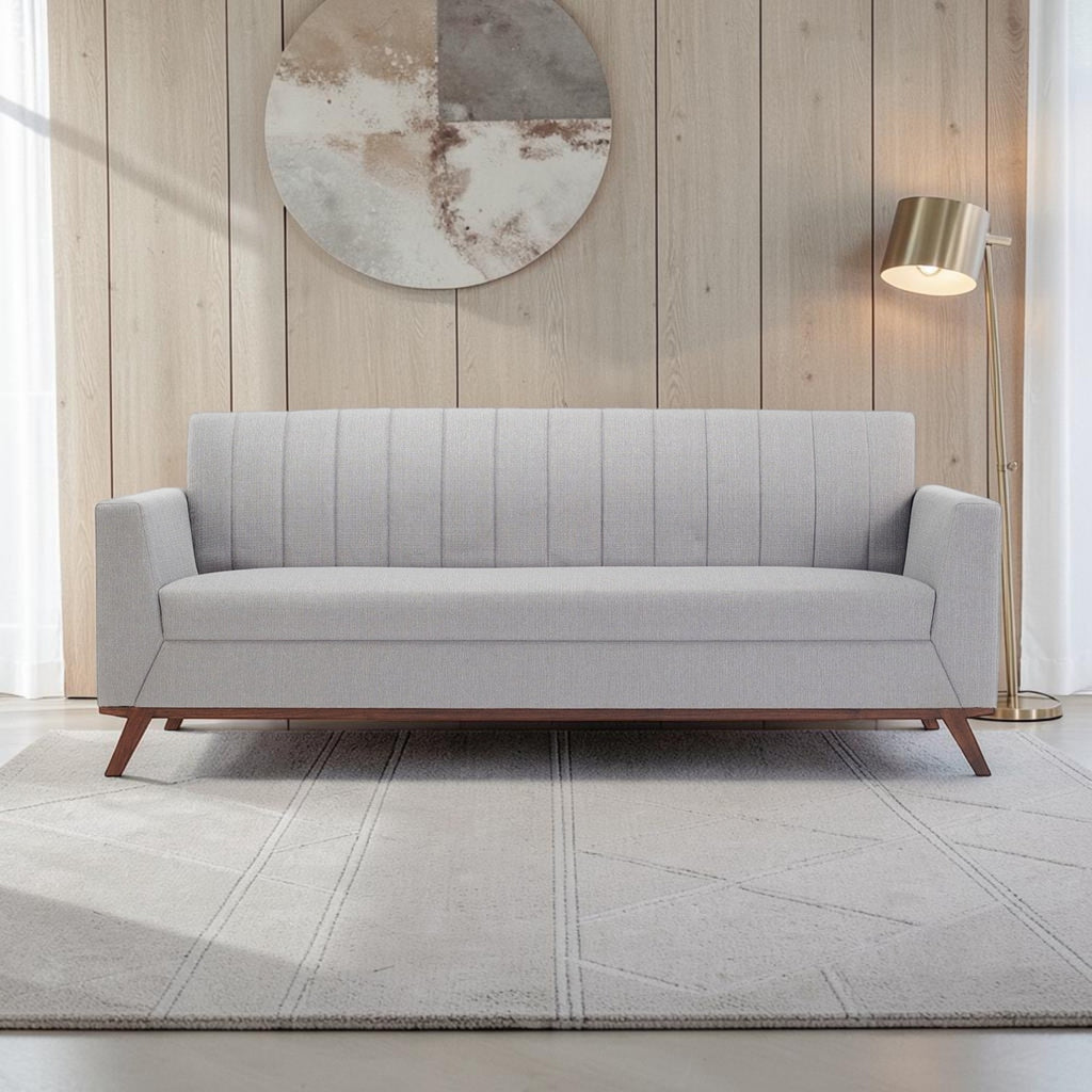Homecrest Lindholm Scandinavian statement sofa in light grey fabric with a teak wood base in a modern living room.