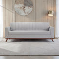 Homecrest Lindholm Scandinavian statement sofa in light grey fabric with a teak wood base in a modern living room.