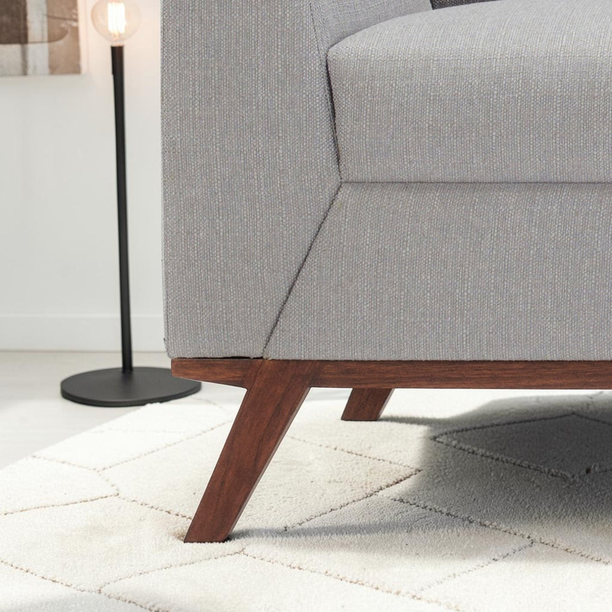 Homecrest Lindholm Scandinavian sofa featuring light grey textured upholstery and a dark teak wood base frame