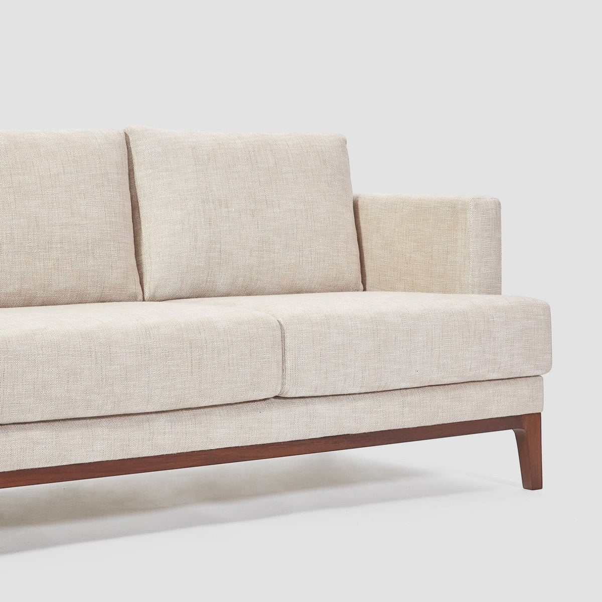 Homecrest Linnea contemporary sofa in parchment fabric with a slim profile, recessed arms, and a solid teakwood base.