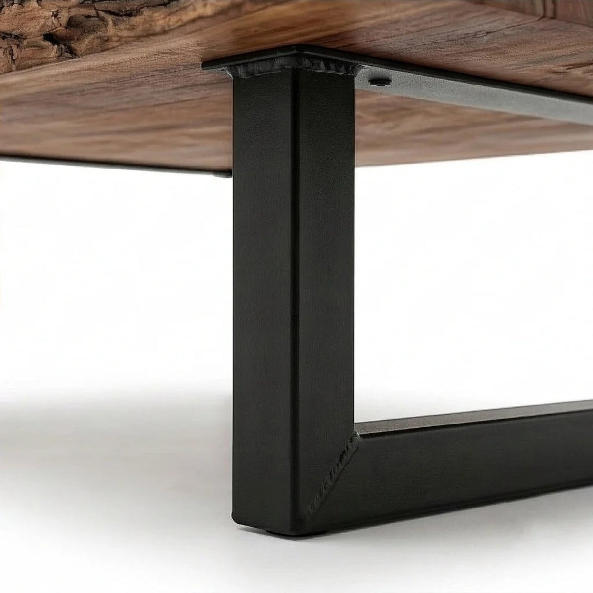 Homecrest Kestrel coffee table featuring a natural live edge solid wood slab and a black powder-coated metal base.