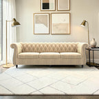 Homecrest Berkley 3-seater Chesterfield sofa in beige velvet with tufted backrest and rolled arms in a modern living room