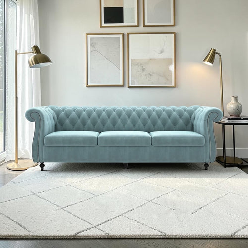 Homecrest Berkley three-seater Chesterfield sofa in dusk blue velvet with button tufting and nailhead trim.