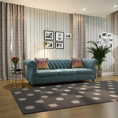 Homecrest Berkley three-seater Chesterfield sofa in dusk blue velvet with tufted back and patterned accent cushions.