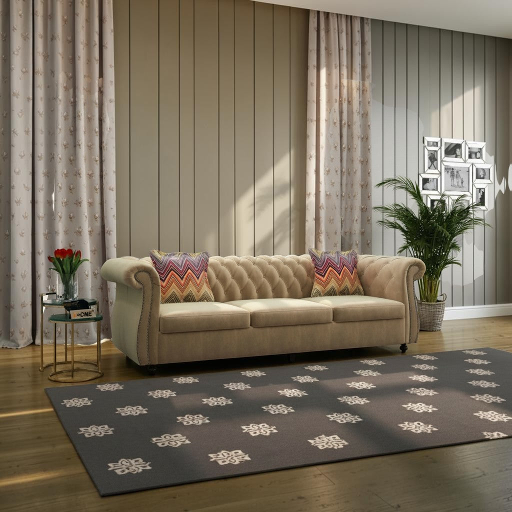Homecrest Berkley Chesterfield sofa in husk velvet with tufted backrest and patterned throw pillows in a living room.