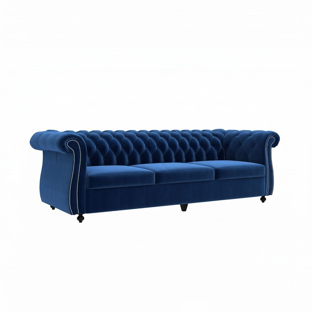 Homecrest Berkley three-seater Chesterfield sofa in indigo blue velvet with button tufting and nailhead trim.