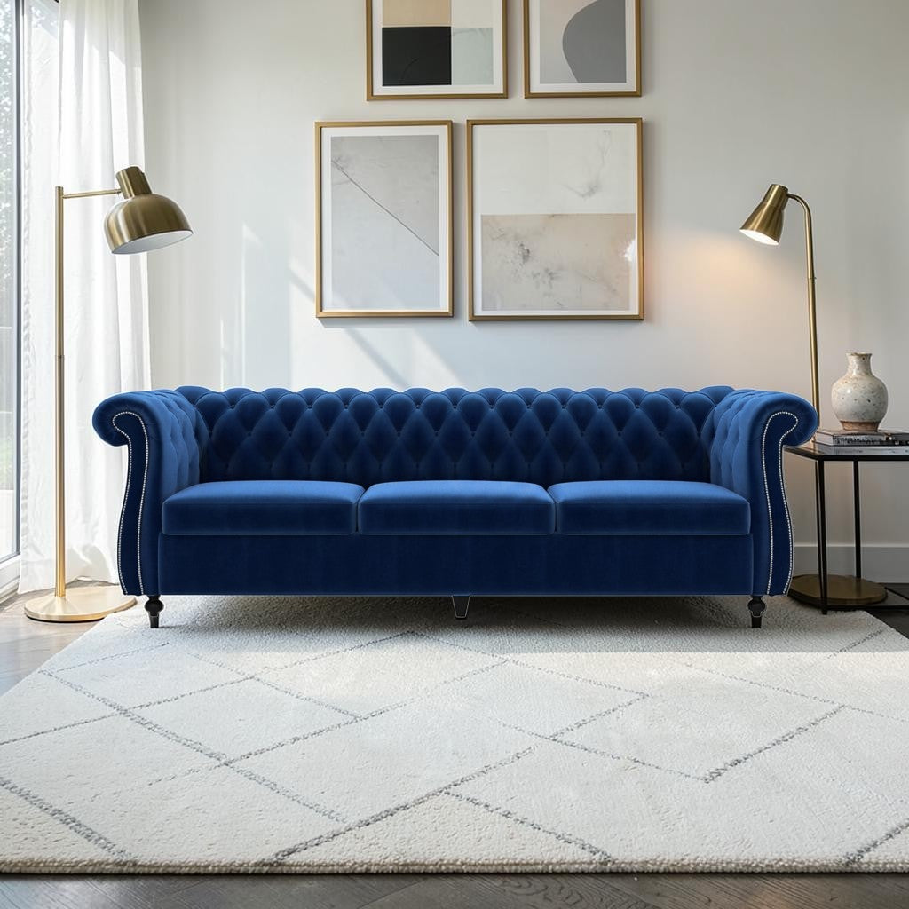 Homecrest Berkley three-seater Chesterfield sofa in indigo blue velvet with tufted back and silver nailhead trim.