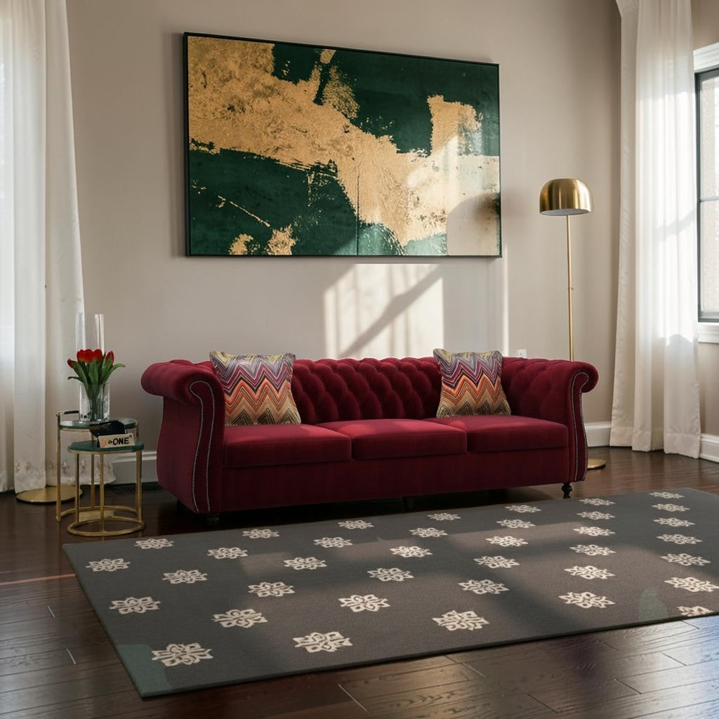 Homecrest Berkley Chesterfield sofa in pomegranate velvet with tufted back and armrests, styled in a modern living room.