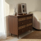 Homecrest Sennen solid sheesham wood chest of drawers with honey finish, rattan drawer fronts, and brass knobs.