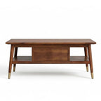 Homecrest Marlowe rectangular coffee table in natural solid wood with a cane drawer, open shelf, and brass leg caps.