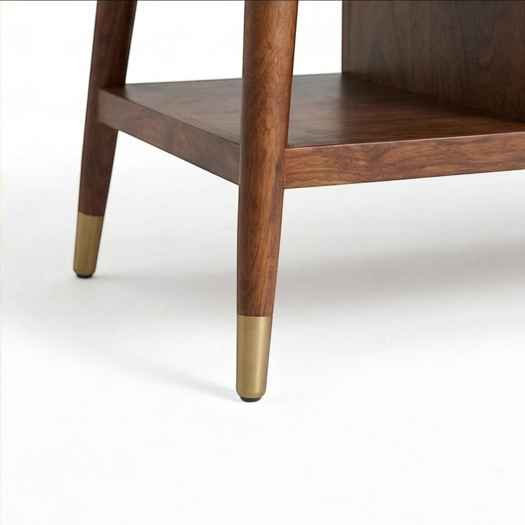 Homecrest Marlowe coffee table featuring solid wood construction, an open shelf, and tapered legs with brass caps.