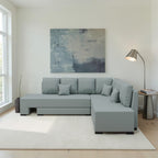Homecrest Merrow L-shape velvet sofa bed in light grey with a lounger, set in a modern living room with a floor lamp.