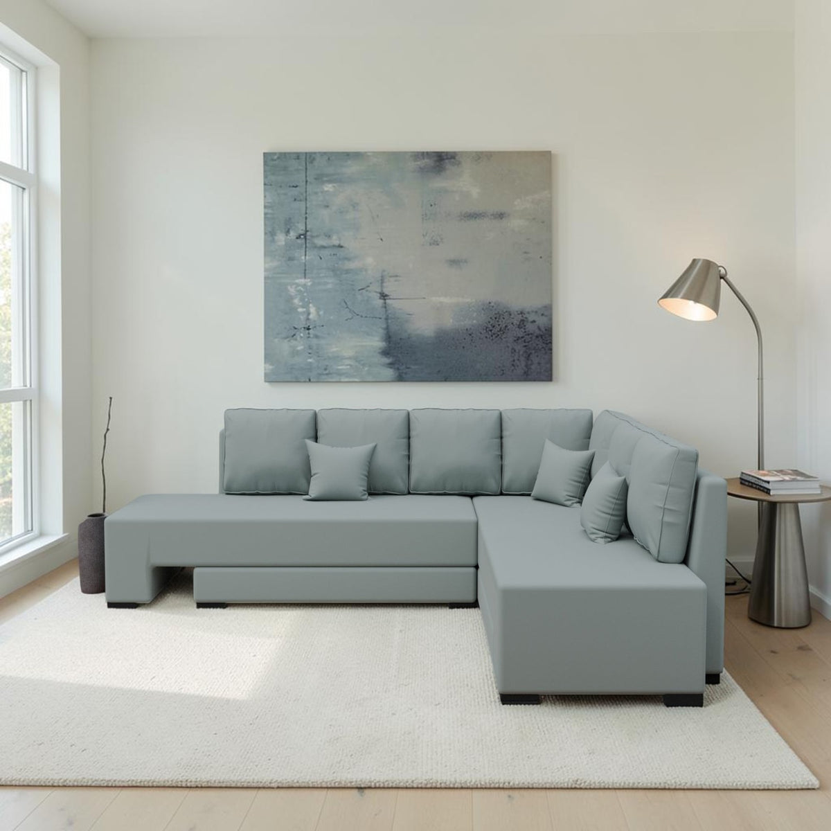 Homecrest Merrow L-shape velvet sofa bed in light grey with a lounger, set in a modern living room with a floor lamp.